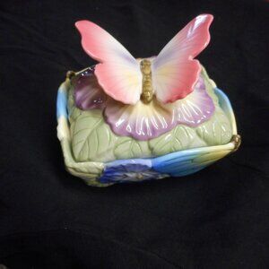 music box lid on this storage box with a butterfly handle
